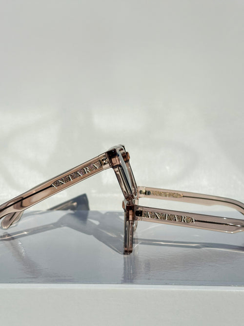 Side detail of the ANTARA Aether Helios frame in transparent beige, showing the lightweight temple construction.
